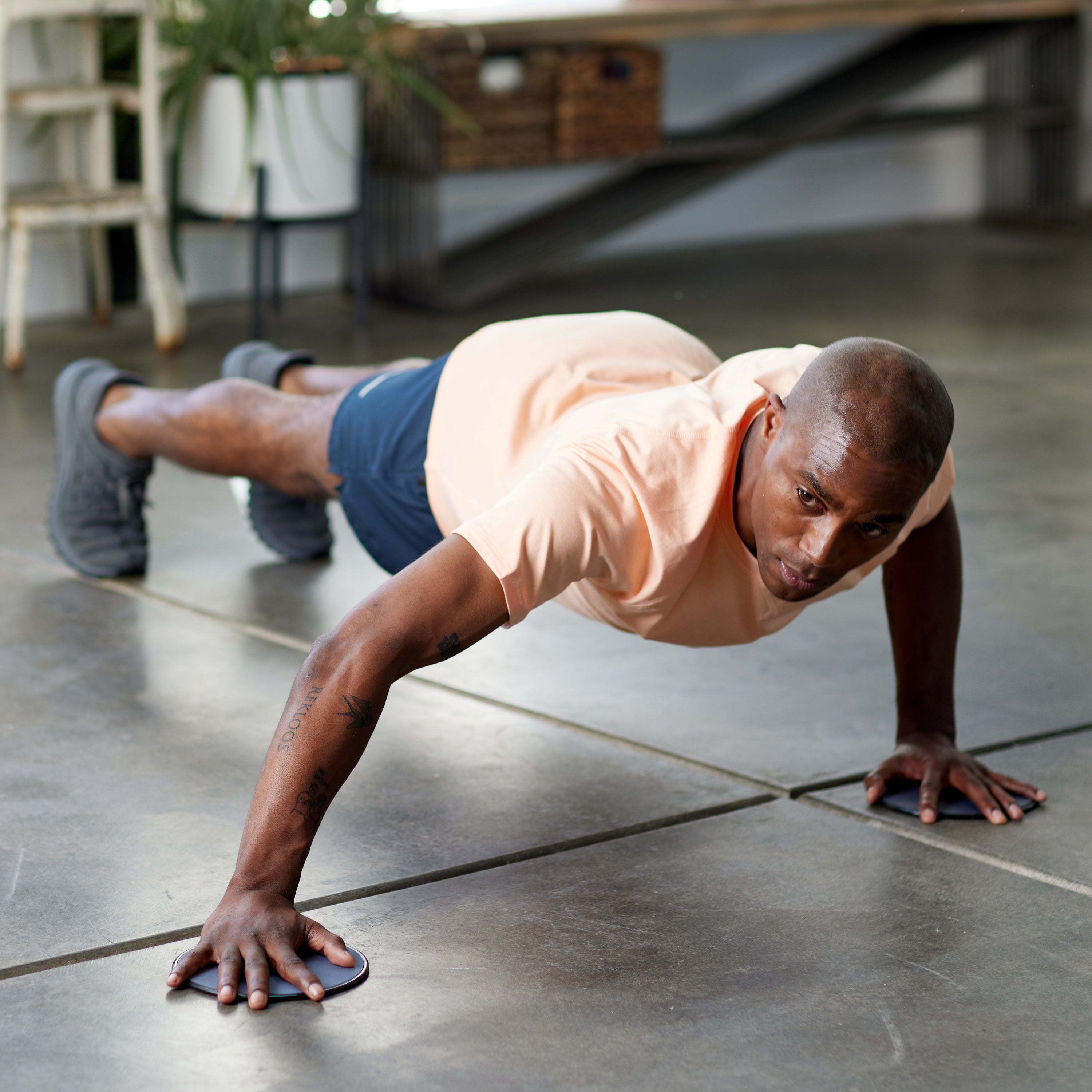 Person doing puh ups with the Core Sliding Discs under the hands